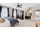 Comfortable bedroom featuring a cozy bed, a desk area, and dark blue curtains, perfect for relaxation and productivity at 1416 Barony Lake Way, Raleigh, NC 27614