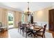 Traditional dining room with a wooden table, chandelier, and access to the backyard at 1416 Barony Lake Way, Raleigh, NC 27614