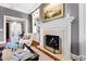 Living room fireplace with a decorative painting above the mantle and built-in shelves at 1416 Barony Lake Way, Raleigh, NC 27614