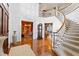 Spacious foyer with hardwood floors, grand staircase, and access to multiple rooms at 1416 Barony Lake Way, Raleigh, NC 27614