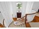 Stunning foyer with a curved staircase and a large window to let natural light in at 1416 Barony Lake Way, Raleigh, NC 27614