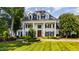 Stately brick home with manicured lawn, mature trees, and stately white pillars at 1416 Barony Lake Way, Raleigh, NC 27614