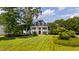 Expansive lawn surrounds this stately brick home with pillared front entry at 1416 Barony Lake Way, Raleigh, NC 27614