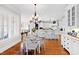 Open floor plan with kitchen island, dining area with chandelier, and hardwood floors at 1416 Barony Lake Way, Raleigh, NC 27614