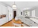 Bright kitchen features white cabinetry, granite countertops, stainless steel sink, and hardwood floors at 1416 Barony Lake Way, Raleigh, NC 27614