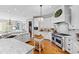 Spacious kitchen with white cabinets, granite countertops, and stainless steel appliances at 1416 Barony Lake Way, Raleigh, NC 27614