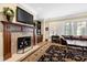 Living room showcases a fireplace with decorative tile, adjacent to a comfortable seating area at 1416 Barony Lake Way, Raleigh, NC 27614