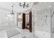 Beautiful main bathroom with a marble shower, soaking tub, and vanity lighting at 1416 Barony Lake Way, Raleigh, NC 27614
