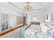 Elegant main bedroom showcasing a chandelier and custom window shutters at 1416 Barony Lake Way, Raleigh, NC 27614