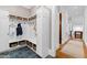 Bright mudroom features custom cabinetry, coat hooks, baskets, and slate flooring at 1416 Barony Lake Way, Raleigh, NC 27614