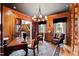 A wood-paneled office featuring built-in shelves, a large desk, and comfortable leather chairs at 1416 Barony Lake Way, Raleigh, NC 27614