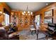 Cozy office space features wood-paneled walls, built-in bookshelves, and leather seating at 1416 Barony Lake Way, Raleigh, NC 27614
