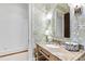 Charming powder room showcasing floral wallpaper and marble countertop at 1416 Barony Lake Way, Raleigh, NC 27614