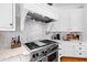 Close-up of a professional grade kitchen range with custom tile backsplash at 1416 Barony Lake Way, Raleigh, NC 27614
