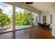 Charming screened porch features wood floors and views of the pool and greenery at 1416 Barony Lake Way, Raleigh, NC 27614