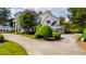 Side view of stately brick home with attached garage and circular driveway at 1416 Barony Lake Way, Raleigh, NC 27614