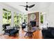 Bright sunroom showcasing wicker seating, a brick fireplace, and views of the backyard at 1416 Barony Lake Way, Raleigh, NC 27614