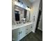 Bathroom with double vanity, modern mirror and lighting fixtures at 151 E Washington St, Coats, NC 27521