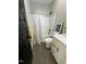 Modern bathroom featuring sleek fixtures, shower-tub combo, and stylish vanity at 151 E Washington St, Coats, NC 27521