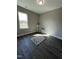 Bright bedroom with a large window, stylish rug, and modern decor at 151 E Washington St, Coats, NC 27521