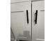Close up on the cabinetry and dark handles of the laundry room storage space at 151 E Washington St, Coats, NC 27521