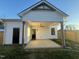 View of a white home featuring a covered patio and a well-maintained lawn at 151 E Washington St, Coats, NC 27521