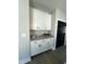 Kitchen area featuring granite counters, modern cabinets, and a view of a black paneled door at 151 E Washington St, Coats, NC 27521