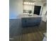 Spacious kitchen island featuring modern gray cabinetry and granite countertop at 151 E Washington St, Coats, NC 27521
