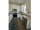 Well-lit kitchen featuring granite countertops, stainless steel appliances and white cabinetry at 151 E Washington St, Coats, NC 27521