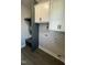 Bright laundry room with white cabinets and dark hardware plus a convenient mudroom space at 151 E Washington St, Coats, NC 27521