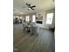This living room has hardwood floors, a fireplace, a ceiling fan, and views into the kitchen at 151 E Washington St, Coats, NC 27521