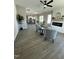 Open floor plan with hardwood floors, fireplace, ceiling fan, and views into the kitchen at 151 E Washington St, Coats, NC 27521