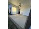 Covered patio features a ceiling fan, and a concrete floor surrounded by a brick border at 151 E Washington St, Coats, NC 27521