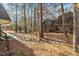 Backyard featuring a small creek bed, trees, and the exterior of the home at 171 Springberry Ln, Chapel Hill, NC 27517