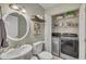Bathroom and laundry room combo featuring modern washer and dryer with ample storage space at 171 Springberry Ln, Chapel Hill, NC 27517