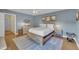 Primary bedroom featuring a king-size bed, a ceiling fan, and light hardwood flooring at 171 Springberry Ln, Chapel Hill, NC 27517