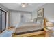Comfortable bedroom featuring a queen bed, two closets, a ceiling fan, and access to an outdoor deck at 171 Springberry Ln, Chapel Hill, NC 27517