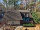 Charming townhouse with a brown shingled roof and a cozy patio, surrounded by lush greenery at 171 Springberry Ln, Chapel Hill, NC 27517