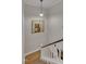 Hallway to the upper floor with wood flooring and a painting on the wall at 171 Springberry Ln, Chapel Hill, NC 27517