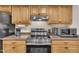 Functional kitchen featuring stainless appliances, warm wood cabinets, and granite countertops at 171 Springberry Ln, Chapel Hill, NC 27517