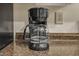 Close up of the countertop-style coffee maker with granite countertop at 171 Springberry Ln, Chapel Hill, NC 27517