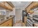 Kitchen showcasing stainless appliances, warm wood cabinets, and granite countertops at 171 Springberry Ln, Chapel Hill, NC 27517