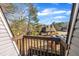 View from a brown wooden railed deck showing trees, rooftops, and cars parked in a lot at 171 Springberry Ln, Chapel Hill, NC 27517