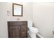 A half-bathroom with modern vanity, mirror, lighting and toilet at 1738 Quail Ridge Rd, Raleigh, NC 27609