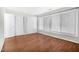 Bright bedroom featuring wood floors, white trim, two windows and large closet at 1738 Quail Ridge Rd, Raleigh, NC 27609