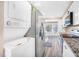Kitchen with stainless steel appliances and stackable washer/dryer at 1738 Quail Ridge Rd, Raleigh, NC 27609