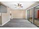 Bright living room featuring wood floors, ceiling fan and sliding door access to patio at 1738 Quail Ridge Rd, Raleigh, NC 27609