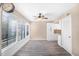 Bright living area with a ceiling fan and large windows showcasing a wooded, private area at 1738 Quail Ridge Rd, Raleigh, NC 27609