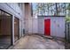 Back patio featuring an exterior storage room, sliding glass doors, and privacy fence at 1738 Quail Ridge Rd, Raleigh, NC 27609