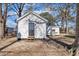 Quaint backyard with a white house, mature trees, and a peaceful setting at 210 Circle Dr, Smithfield, NC 27577